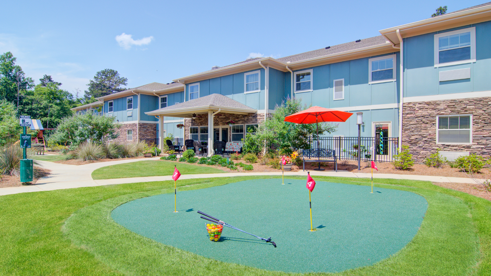 Daytime exterior photograph of a senior living recreational area