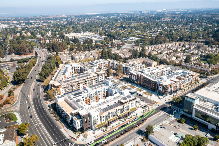 Daytime exterior drone photograph of apartment community