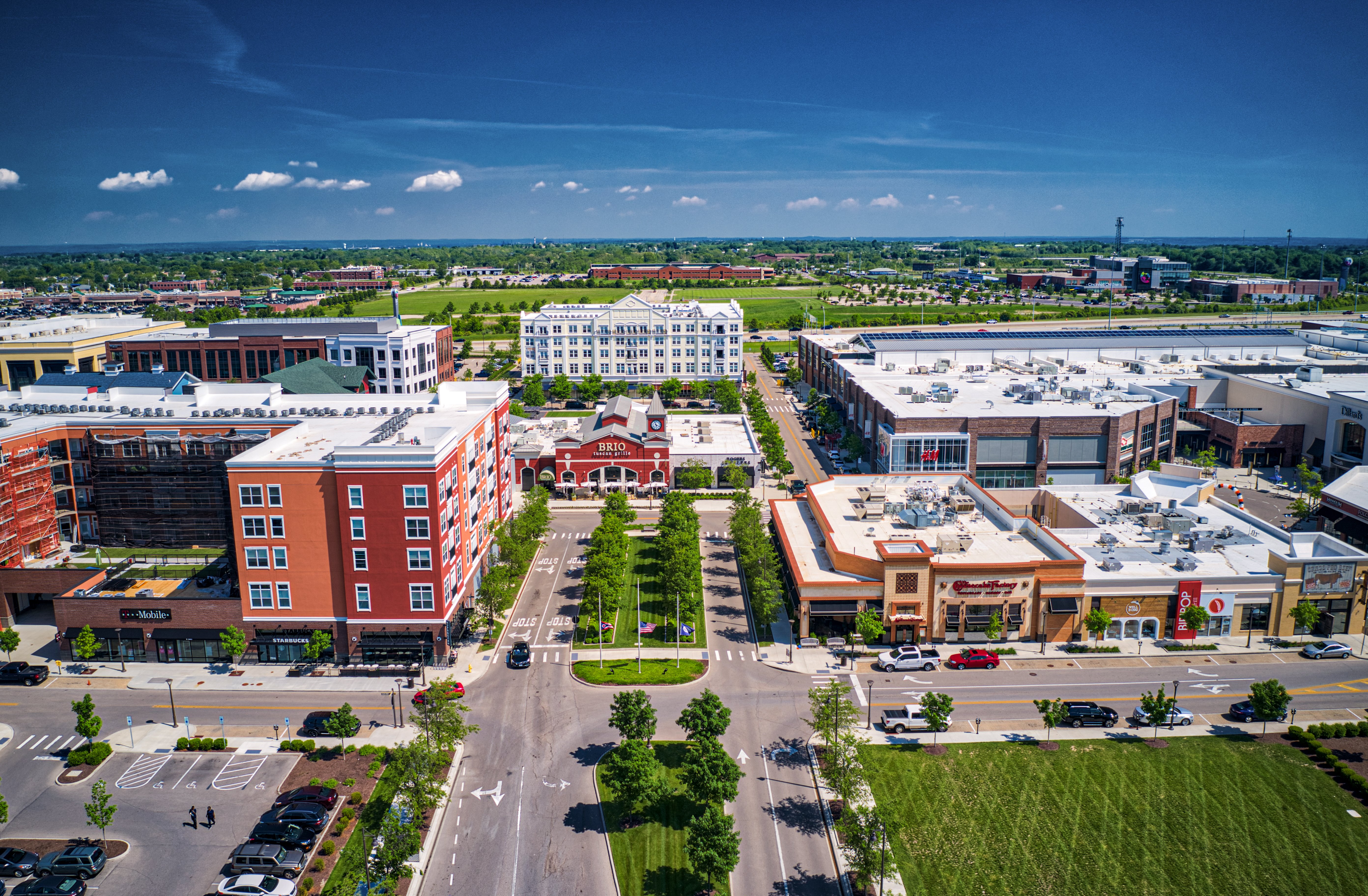 Daytime exterior drone photograph of apartment community