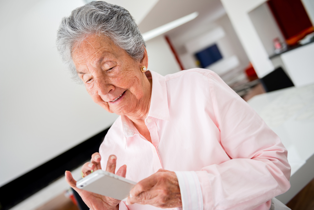 Happy senior woman using app on a cell phone