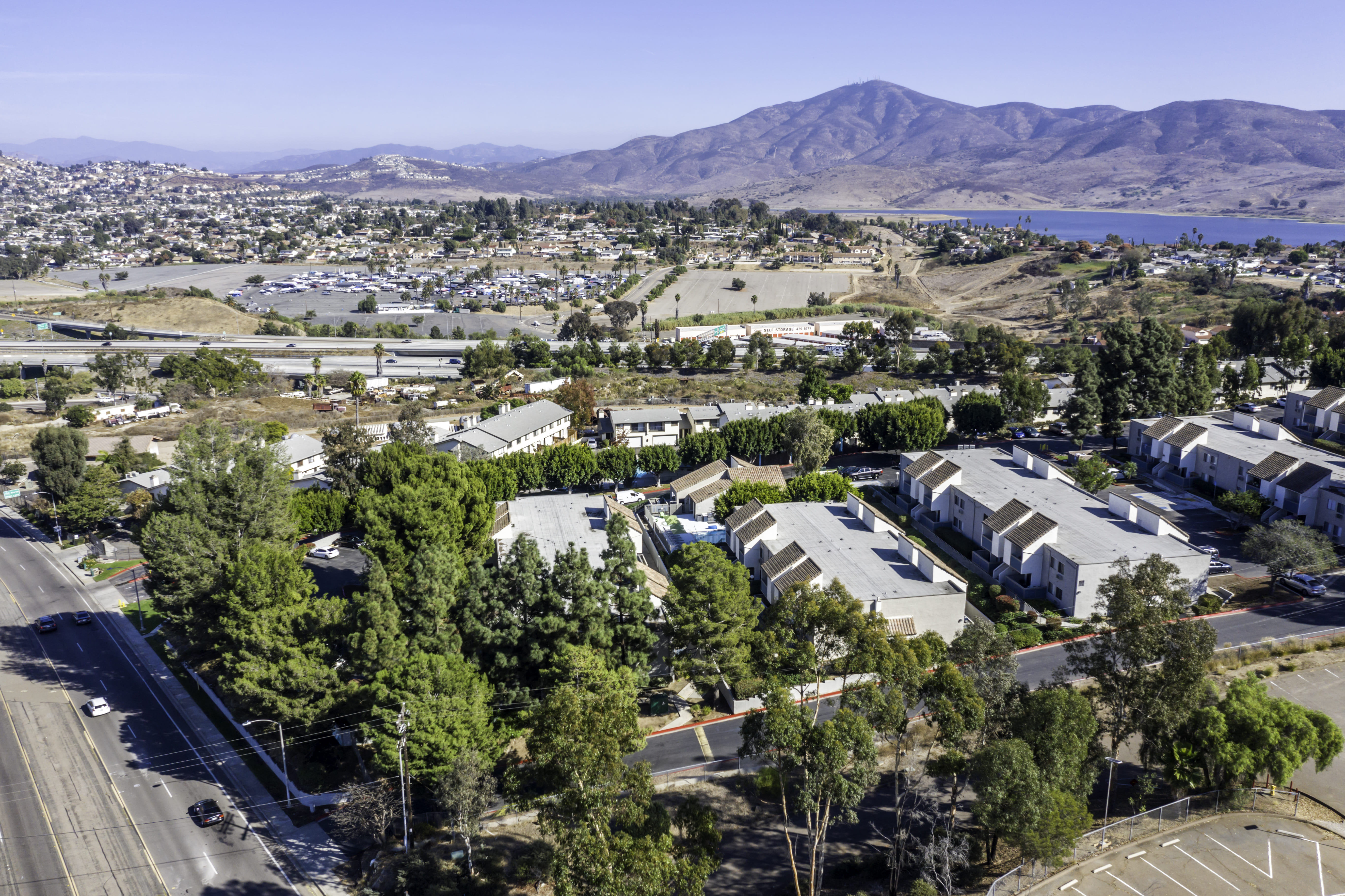 Daytime exterior drone photograph of apartment community