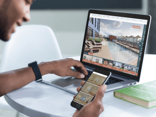 young-man-working-on-his-macbook-pro-laptop-and-iphone-6-mockup